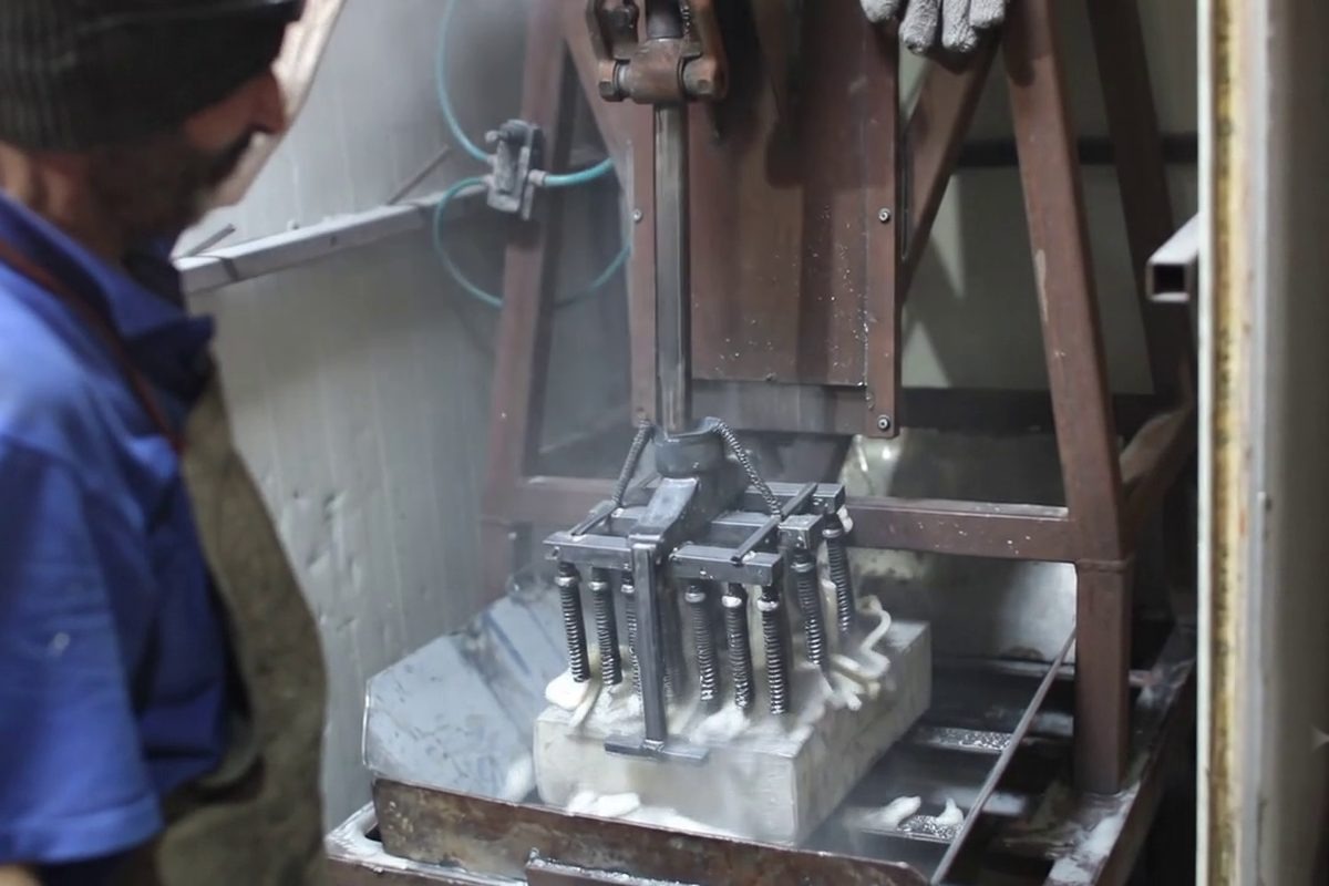 Ceramic mould broken away in the knockout machine, revealing the cast metal, Gerra atelier